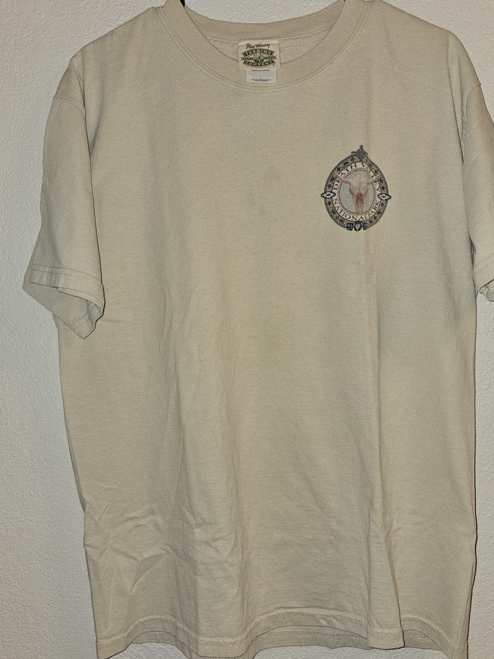 vintage beige graphic tee likely dates back to the 1990s